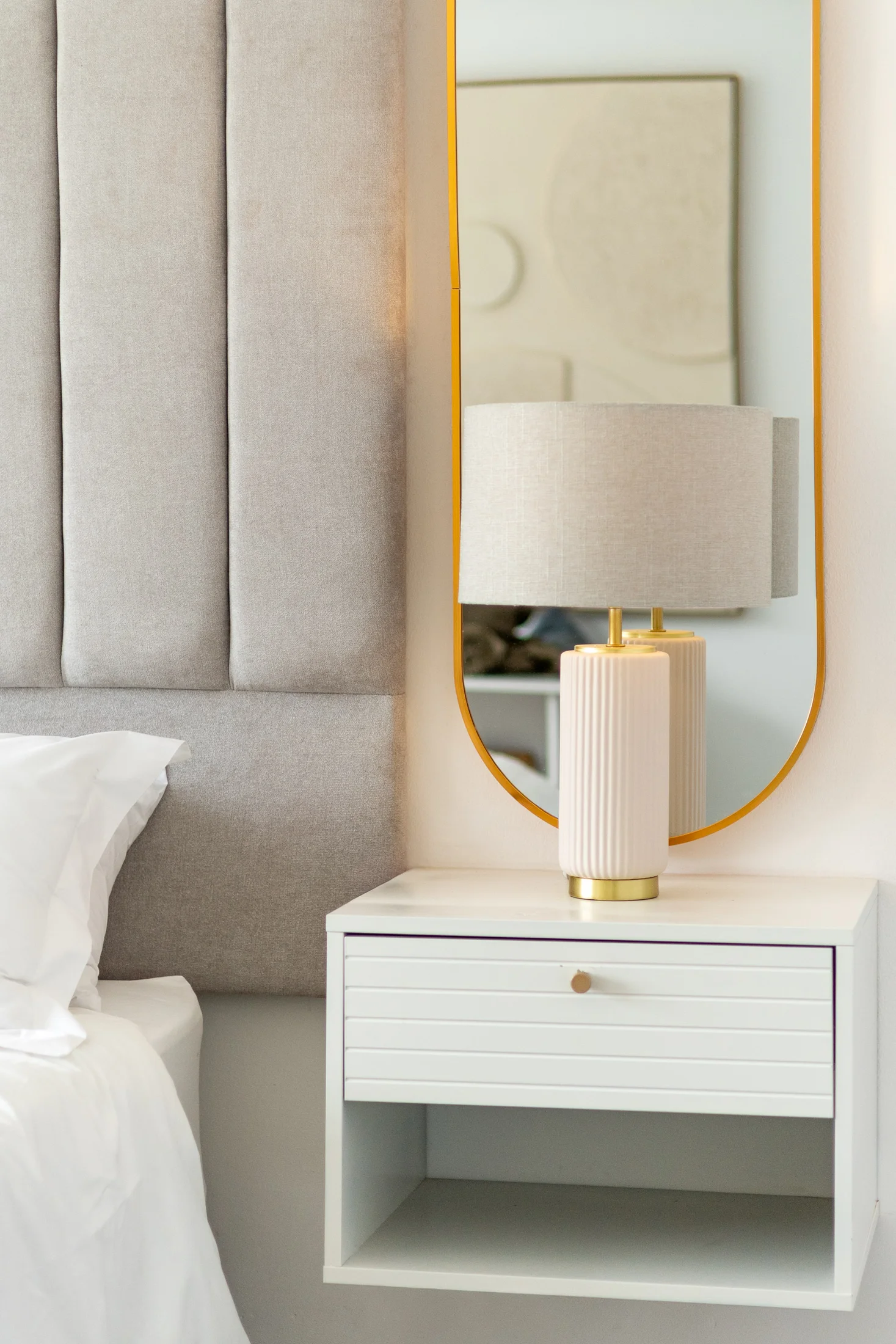 Bedside lamp, mirror and upholstered headboard