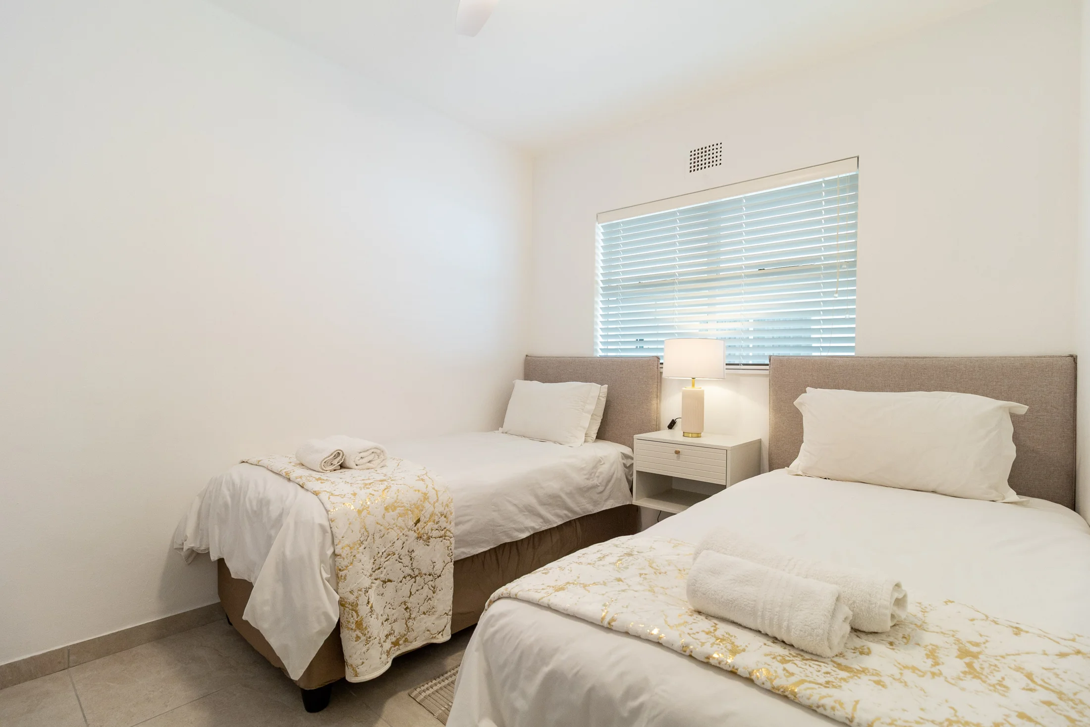Twin bedroom in soft neutrals